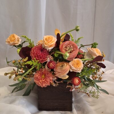 Our Fall arrangement has peach roses,dahlias, ranunculus and mokara orchids