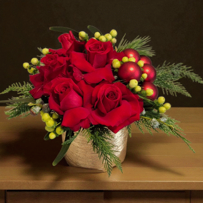 Here is a holiday classic in red and gold featuring red roses, stem balls, green coffee beans and Christmas greens in a gold vase.